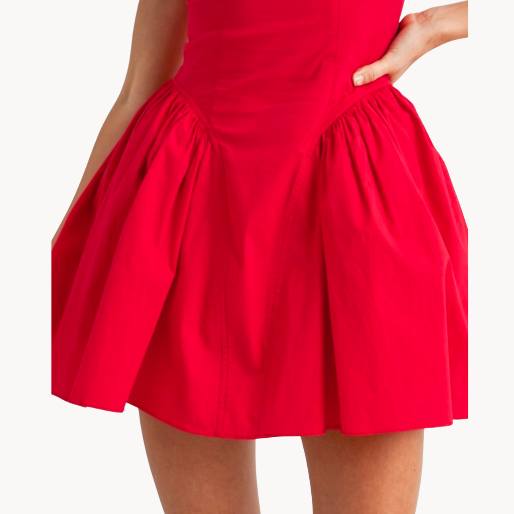 Red corset-style mini dress with pleated skirt and lace-up back – flirty and bold date night outfit or party dress for women.