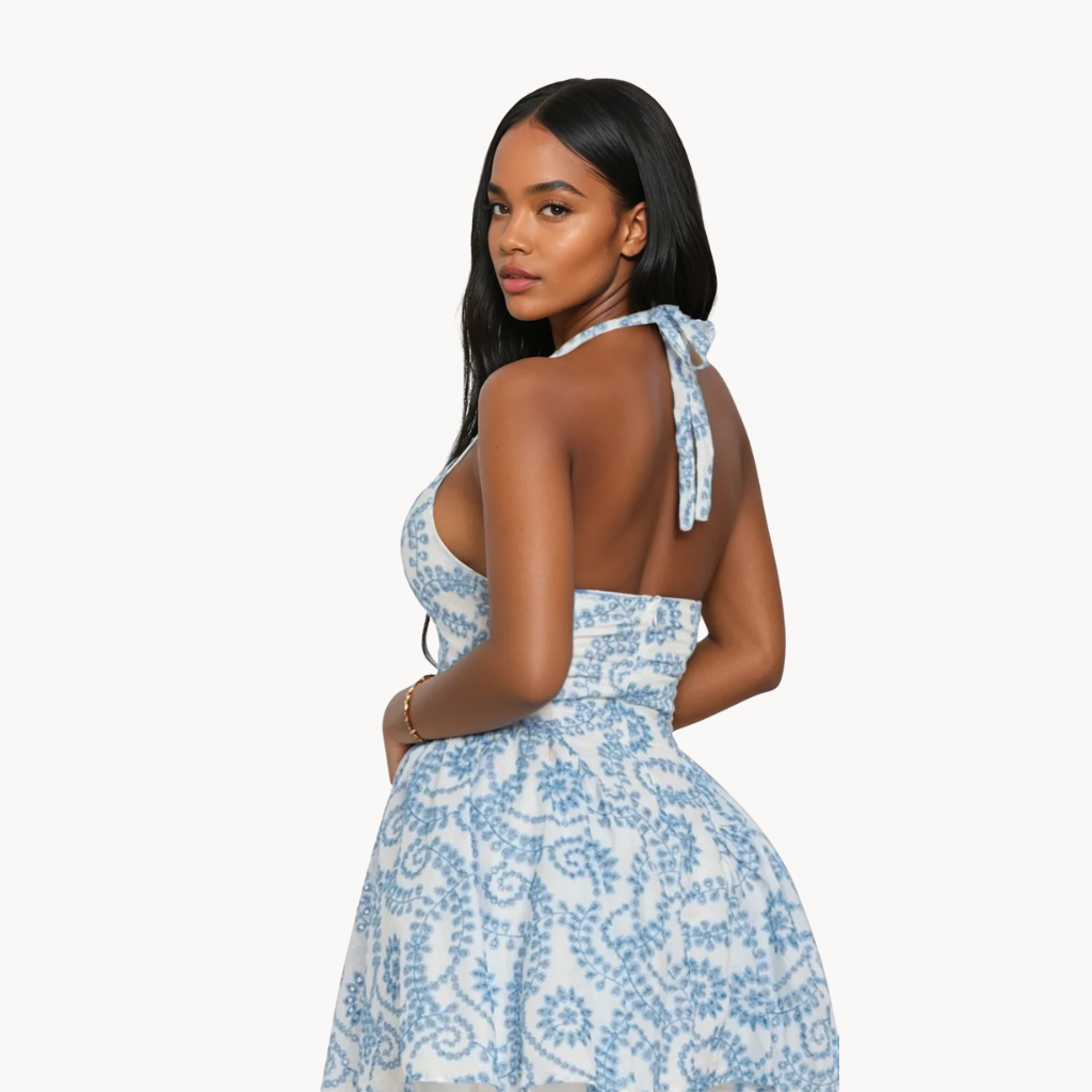 Blue and white halter mini dress with floral swirl print and deep V neckline – summer party dress or beach vacation outfit for women.