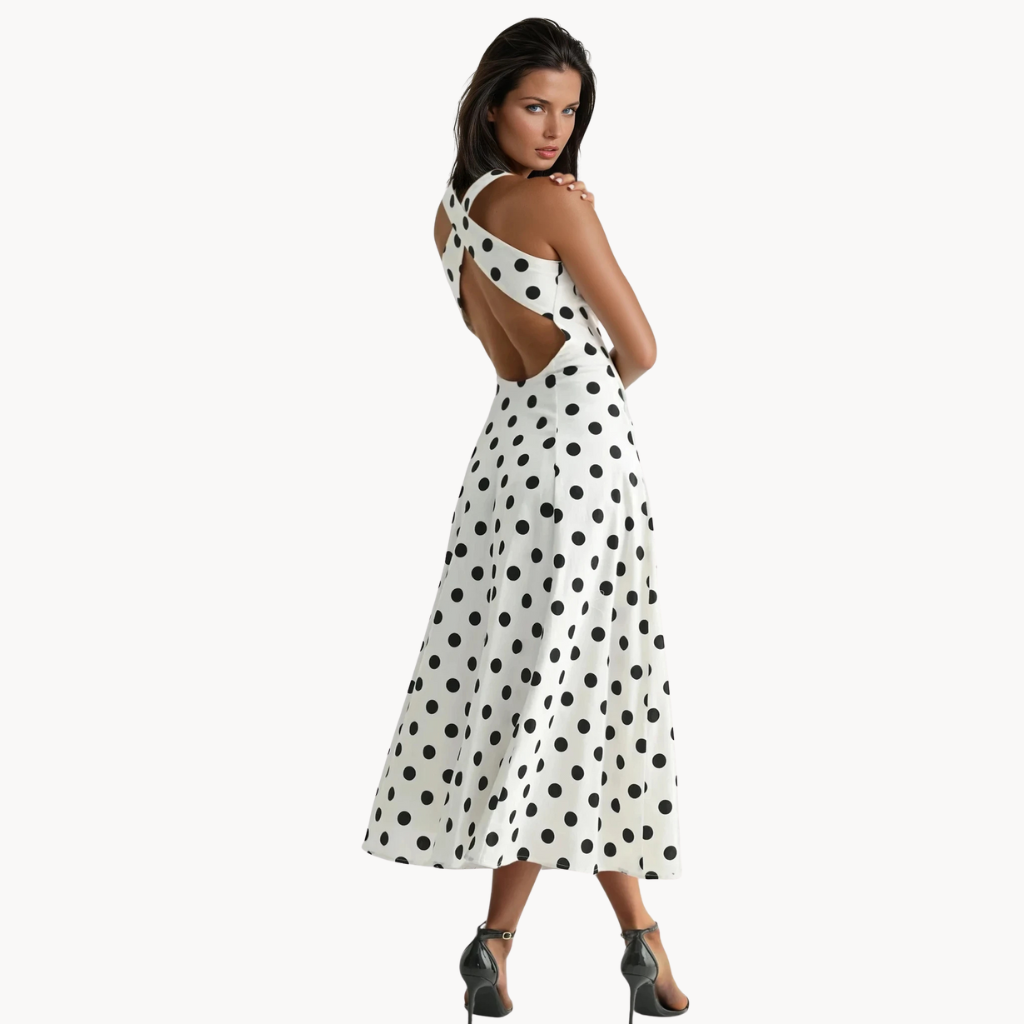 White midi dress with black polka dots, wide straps, and flared silhouette – vintage-inspired brunch dress or classy summer outfit for women.