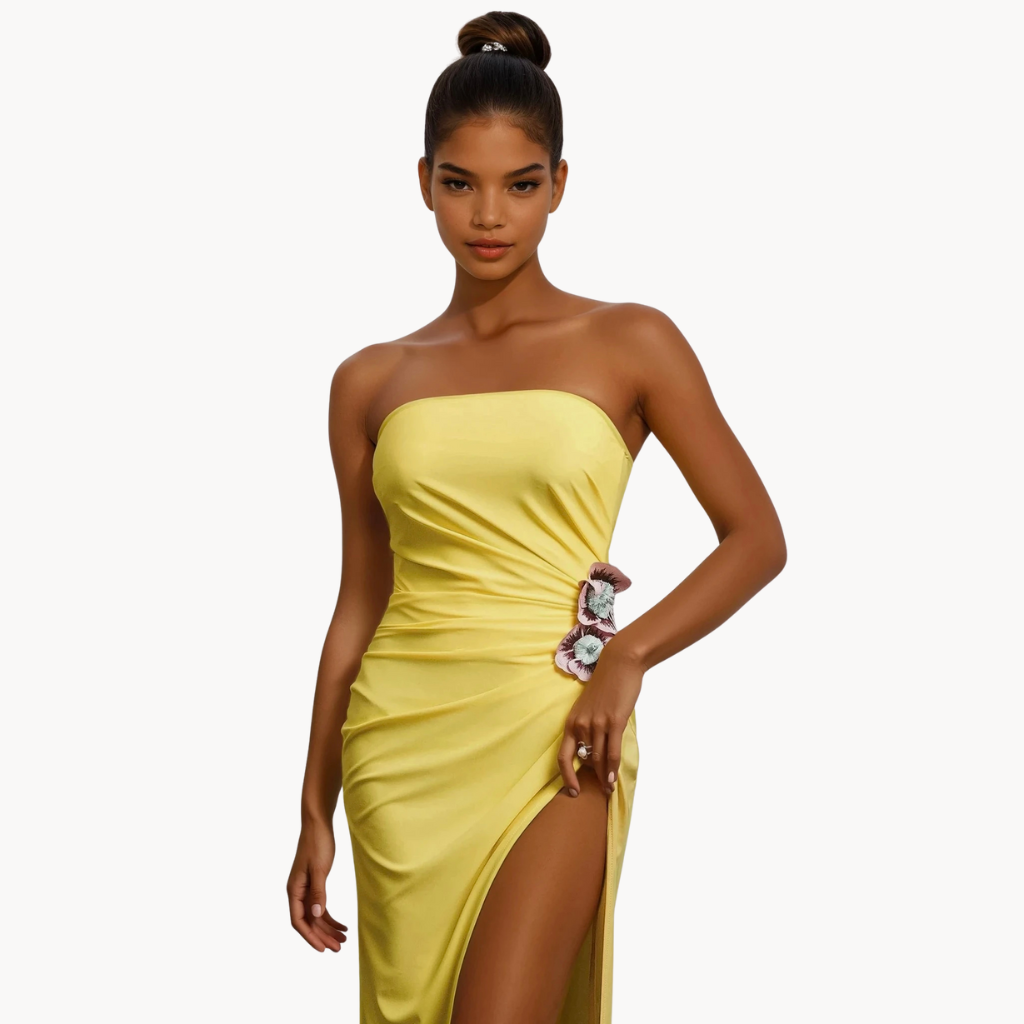 Yellow strapless gown with side slit, floral applique detail, and ruched fit – statement evening dress or summer wedding guest outfit for women.