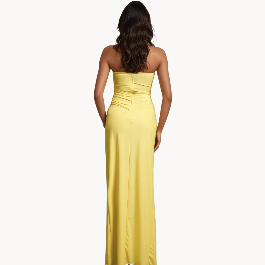 Yellow strapless gown with side slit, floral applique detail, and ruched fit – statement evening dress or summer wedding guest outfit for women.