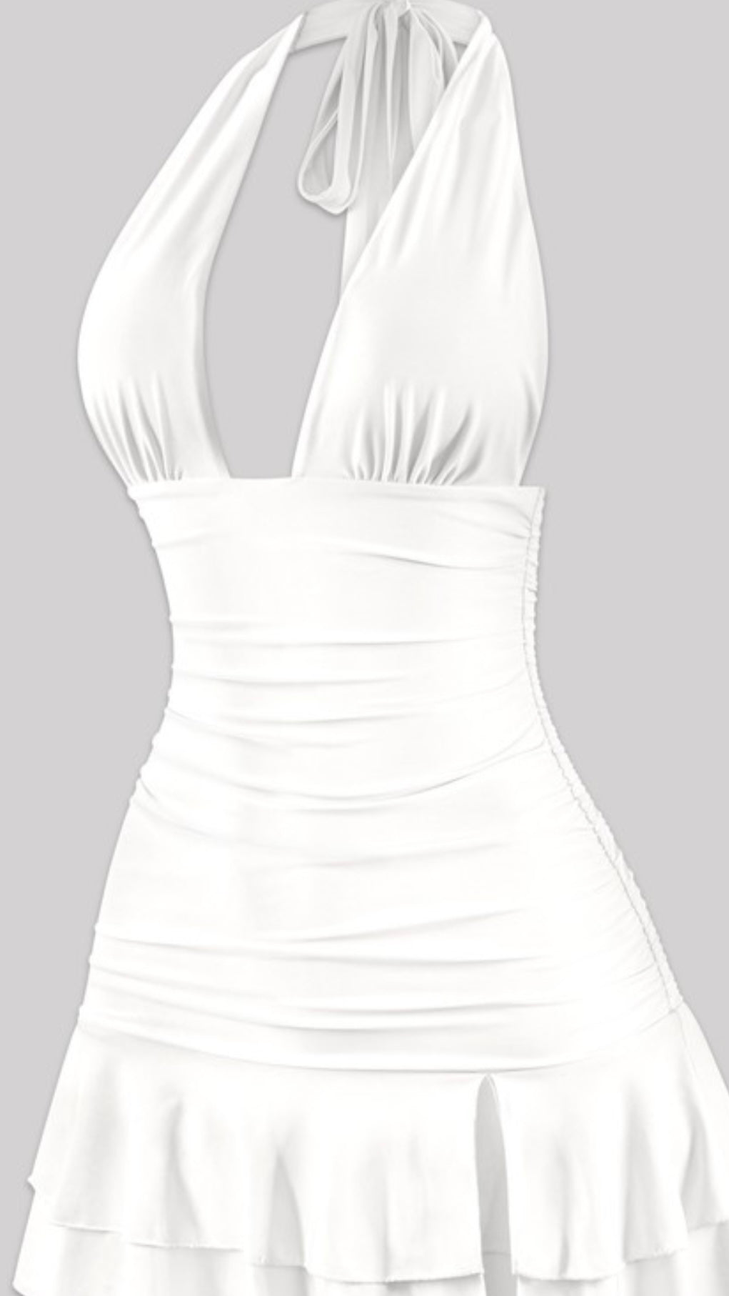 White halter mini dress with deep V neckline, ruched sides, and layered ruffle hem – flirty summer dress or bachelorette party outfit for women.