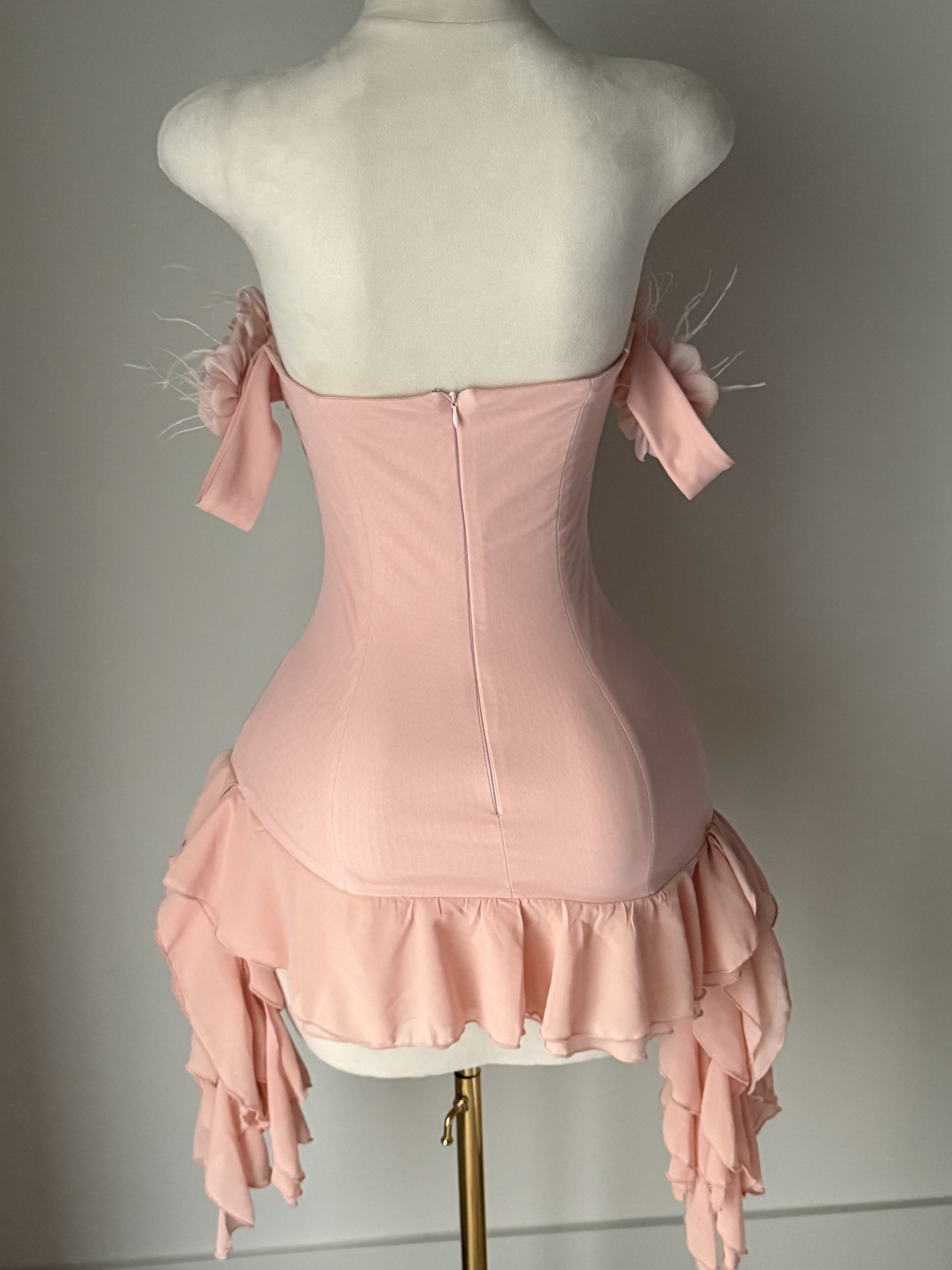 Blush pink off-shoulder mini dress with 3D floral details, feather accents, and layered ruffle hem – romantic occasion dress or birthday outfit for women.