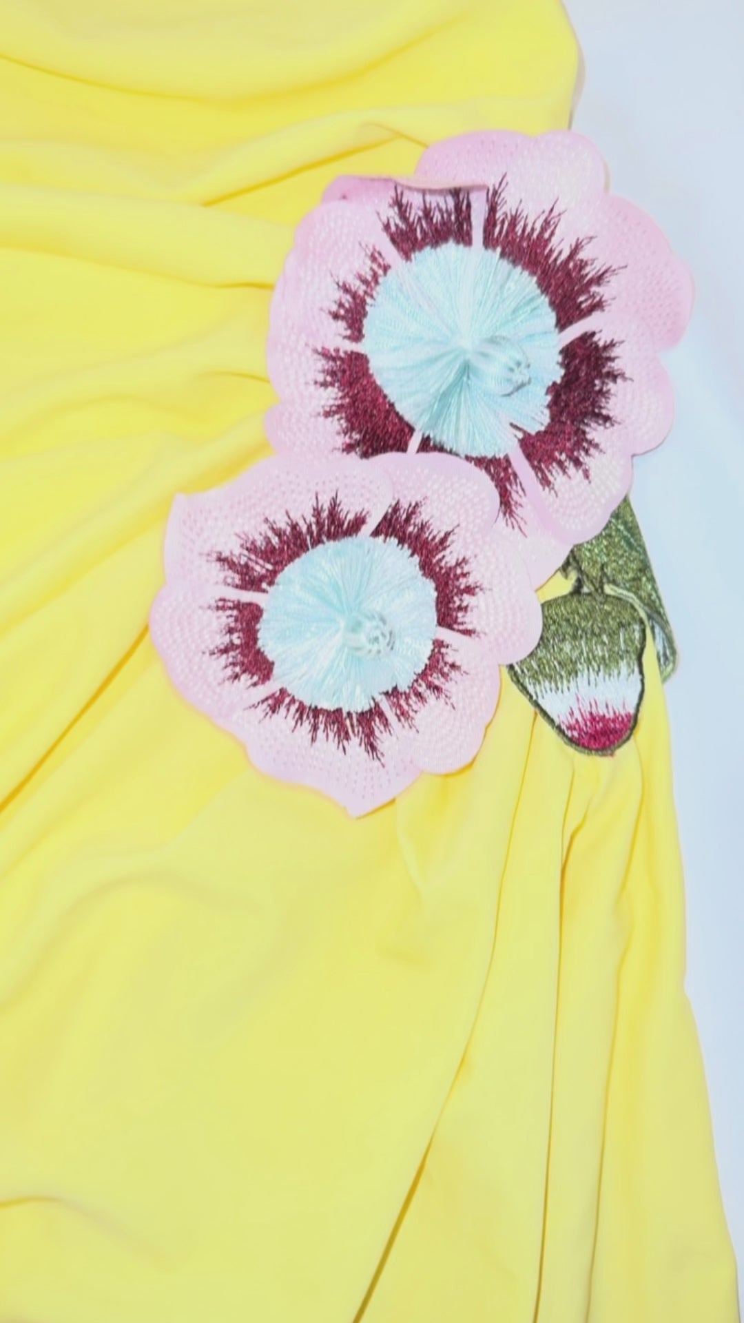 Yellow strapless gown with side slit, floral applique detail, and ruched fit – statement evening dress or summer wedding guest outfit for women.